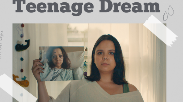 A female survivor of gun violence holding a picture of herself in the hospital recovering from her wounds. 